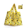 A yellow reusable shopping tote bag with a patterned fabric carry pouch attached.