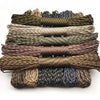 A stack of ten 100-foot paracord ropes in various colors and thicknesses for camping and climbing.
