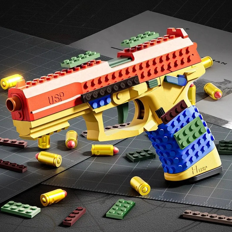 A yellow building block toy pistol with a red and green firing mechanism and shell ejecting action, set against a dark backgr