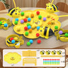 A yellow board game featuring bee-shaped pieces and yellow and green colored balls on a wooden table.