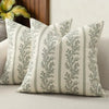 A close-up of a vintage striped floral throw pillow cover with sage green foliage pattern.