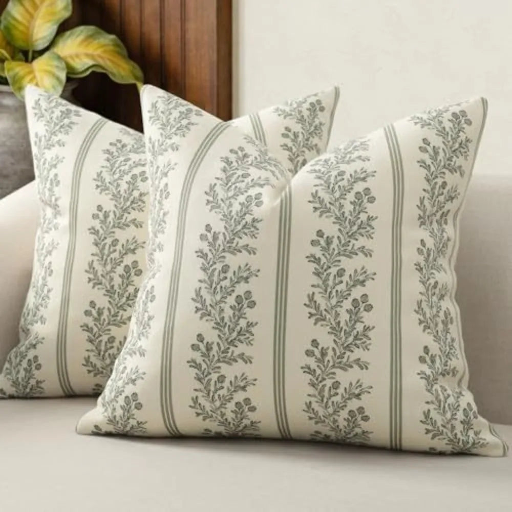A close-up of a vintage striped floral throw pillow cover with sage green foliage pattern.