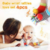 A woman is holding a baby while showing a set of four baby wrist rattles toys