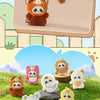 A hand is holding an adorable orange panda plush toy against a light background.