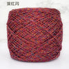 A ball of deep red metallic silk crochet yarn with an intricate woven texture.