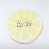 A yellow citrus fruit design with the word LUCKY printed on it, used as a waterproof shower cap.