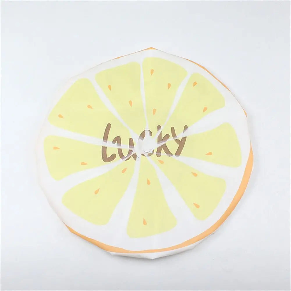 A yellow citrus fruit design with the word LUCKY printed on it, used as a waterproof shower cap.