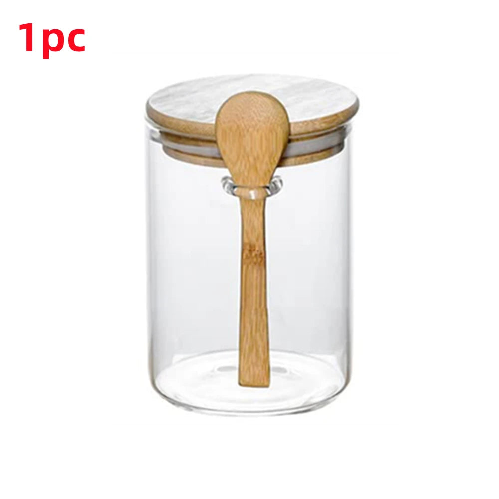 A clear glass storage jar with a bamboo lid and spoon, sealed for airtight storage.