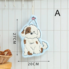 A light blue cartoon dog hanging towel with brown markings and a pink star, displayed against a white grid background.
