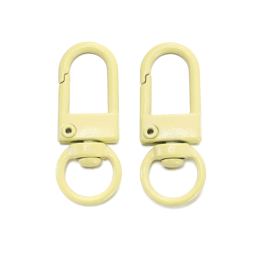 A pair of light yellow alloy lobster clasp hooks for DIY jewelry making