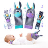 A set of soft baby wrist rattles and foot finder socks featuring cute animal designs for newborns.