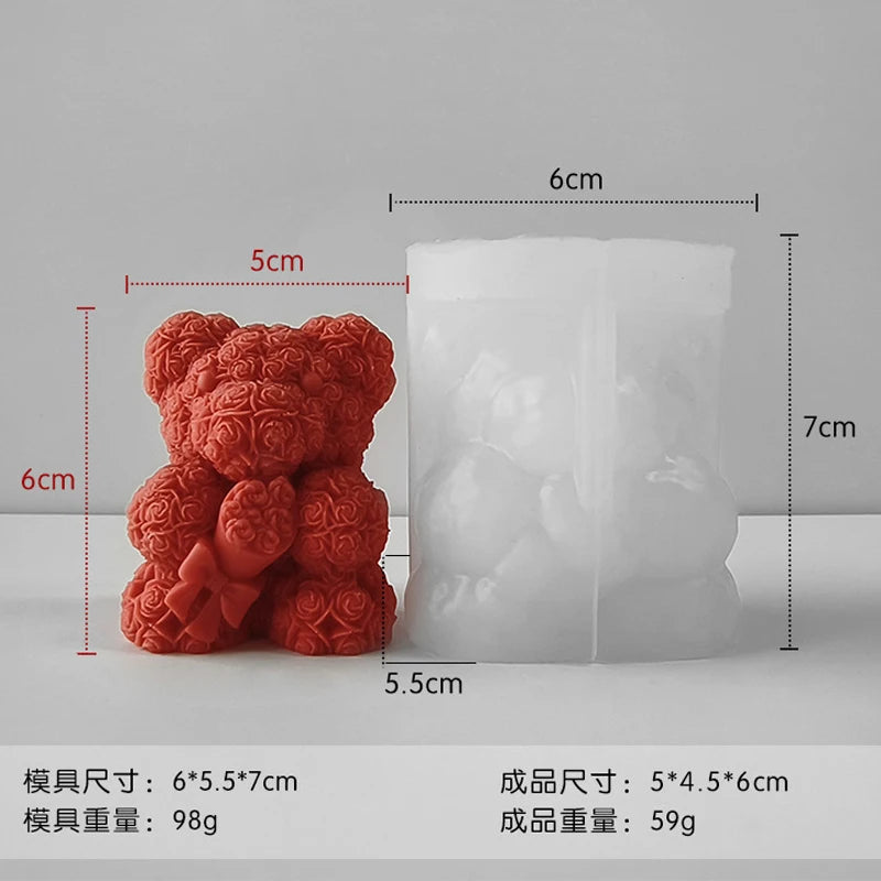 A white silicone mold shaped like a bear hug rose, shown next to its corresponding pink silicone parts.
