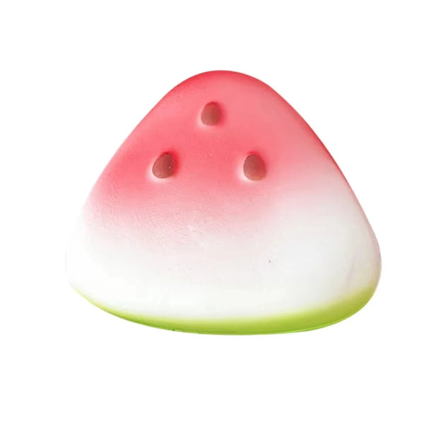 A pink and white watermelon-shaped squishy fidget toy with visible holes.