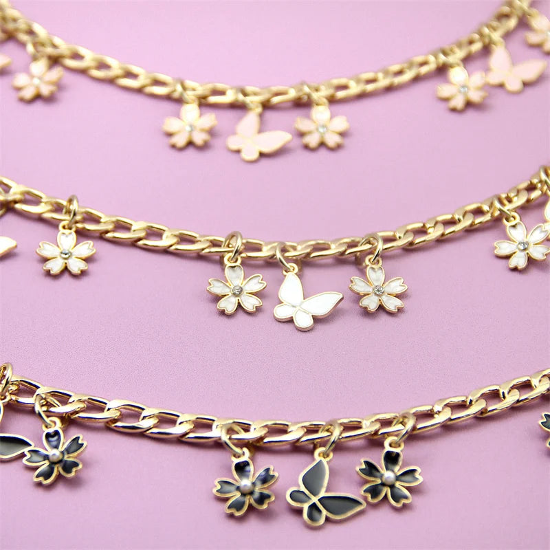 Gold chain necklace with small flower charms and pearl accents
