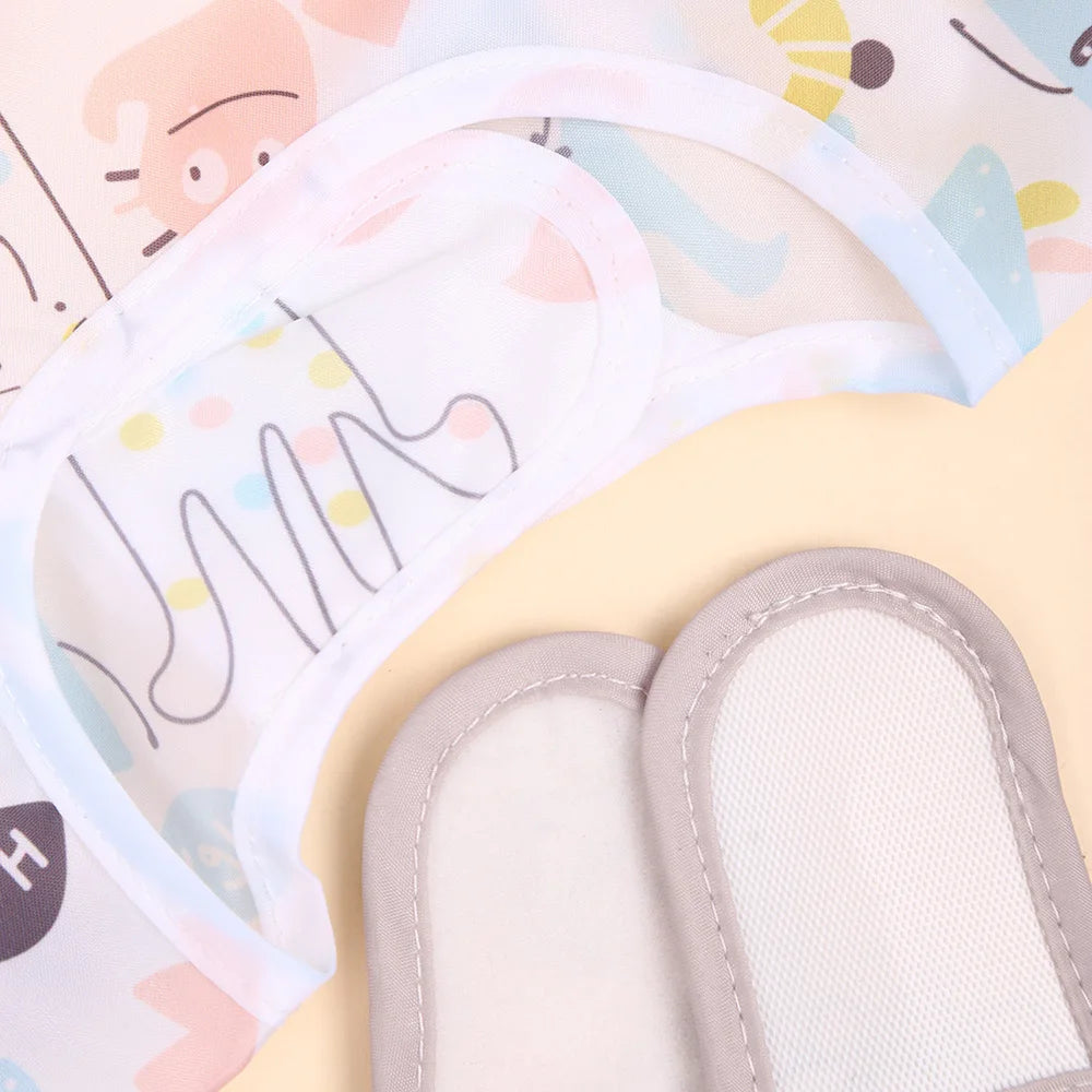 A light blue and pink waterproof long-sleeve baby bib is shown with its attached padded insert.