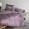 A luxurious lavender silk duvet cover set displayed on a bed with soft lighting.