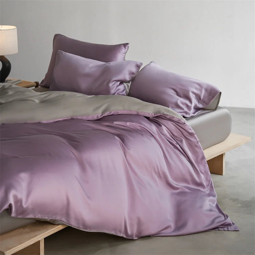 A luxurious lavender silk duvet cover set displayed on a bed with soft lighting.