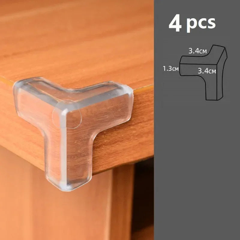 Four clear silicone corner edge guards used to protect baby safety on a wooden surface.