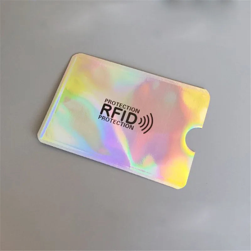 A translucent, iridescent aluminum card holder with the text Protection RFID Protection printed on it.