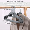 A gray plastic hanger is shown hanging on a wooden rod, demonstrating its size and use for clothing storage.