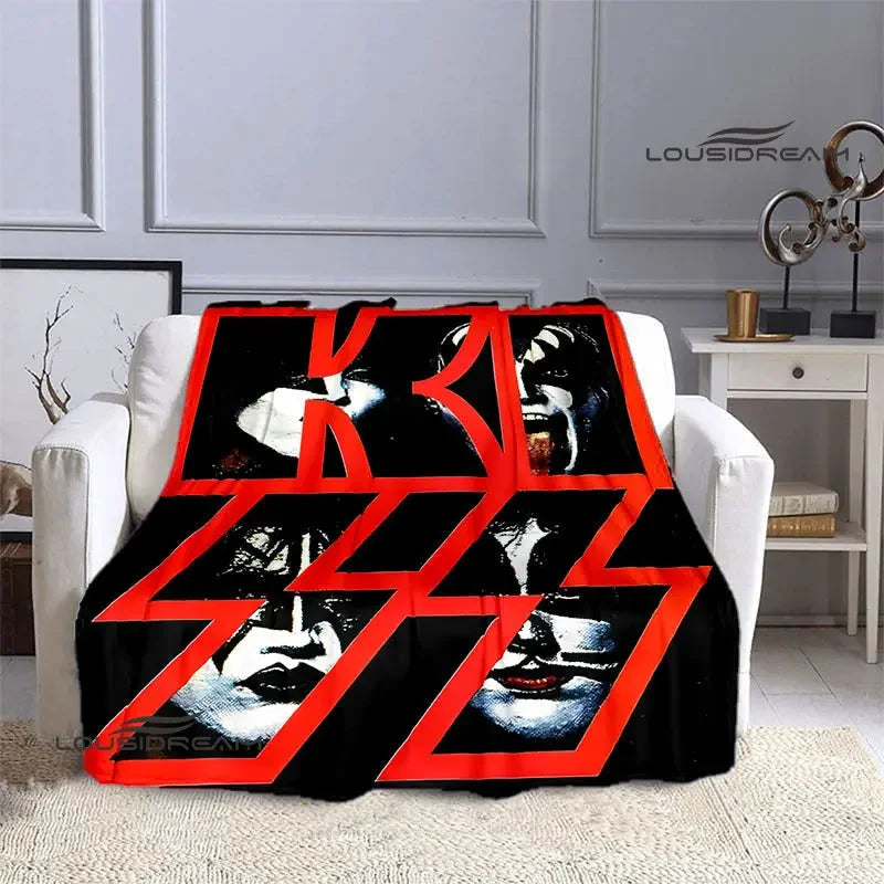 A black and red flannel throw blanket featuring repeated images of the KISS band members' faces.