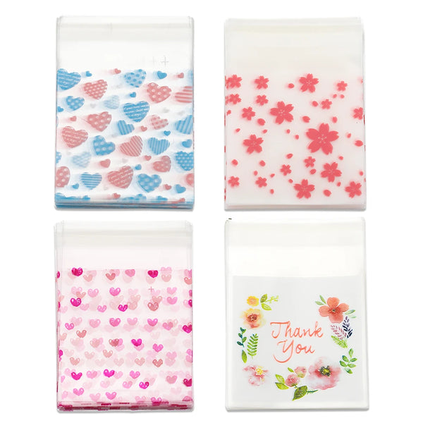 A set of clear self-adhesive treat bags filled with pink and blue heart-shaped candies.