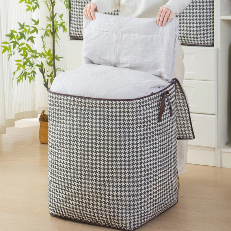 A quilted storage bag with handles in a black and white houndstooth pattern sits on the floor.