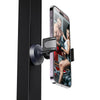 A magnetic phone holder is attached to a black door, displaying a fitness model in a gym setting.