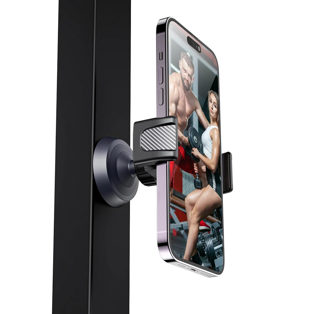 A magnetic phone holder is attached to a black door, displaying a fitness model in a gym setting.