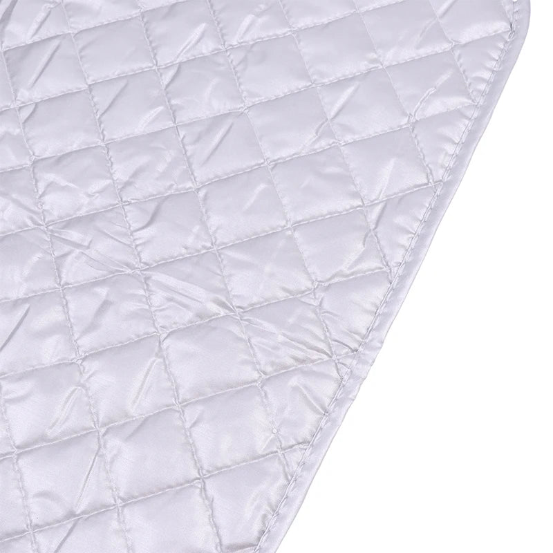 A white quilted heat-resistant ironing mat shown from an angle.