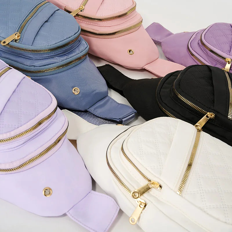 A collection of quilted crossbody sling bags in various shades of purple, pink, blue, and black.