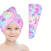 A pink microfiber hair drying towel wrap featuring a vibrant unicorn print, shown next to a child's face.
