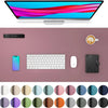 A computer monitor displaying a vibrant image, a smartphone, a keyboard, a mouse, and various colored pads.