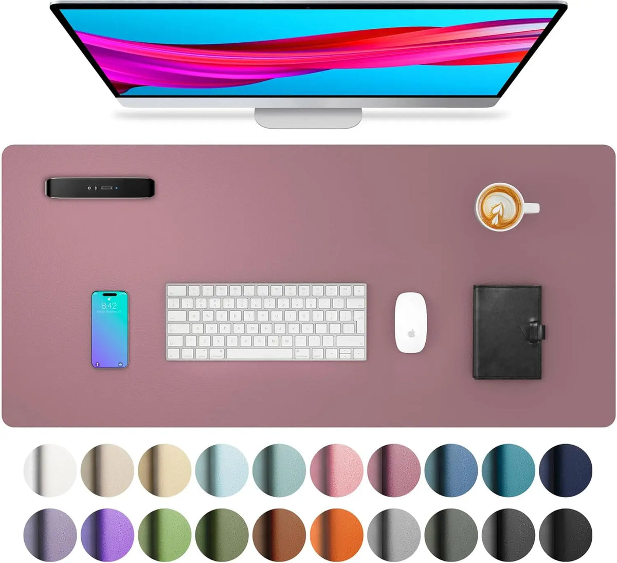 A computer monitor displaying a vibrant image, a smartphone, a keyboard, a mouse, and various colored pads.
