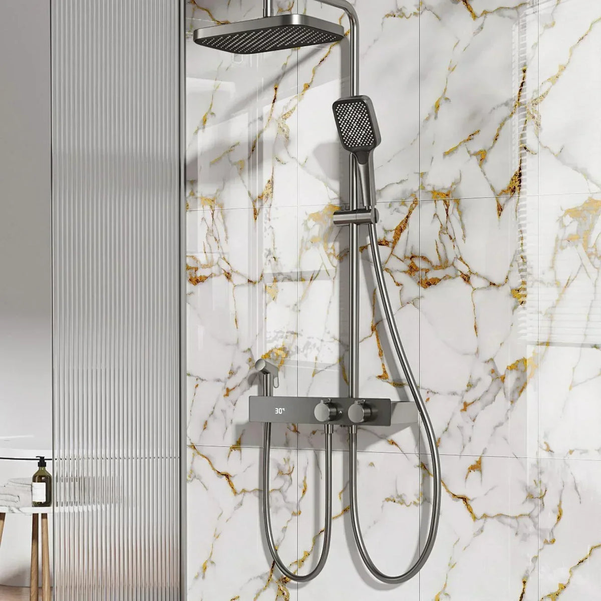 A modern shower fixture with a handheld showerhead is mounted on a white marble-effect tiled wall.