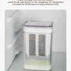 A clear plastic yogurt strainer with a fine mesh filter is placed inside a refrigerator for natural draining.