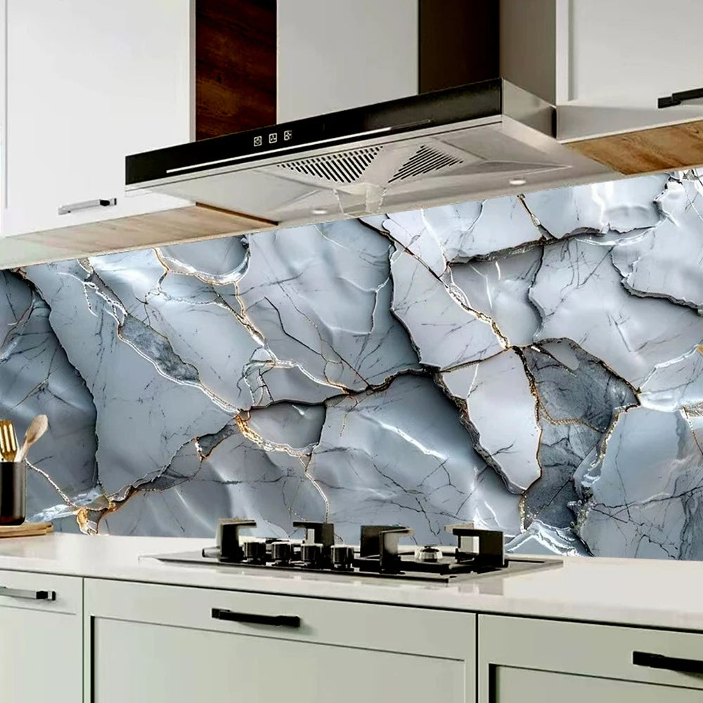 A kitchen backsplash featuring a gray marble pattern with gold veining and a stainless steel range hood.