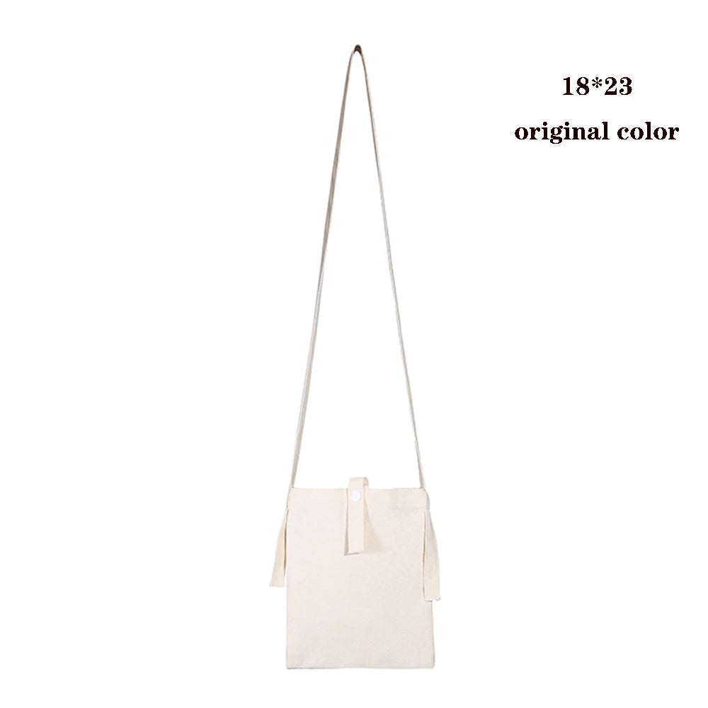 A light beige foldable canvas tote bag with long straps shown against a white background.