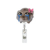 A cute hamster face charm on a clear acrylic badge reel with an alligator clip.