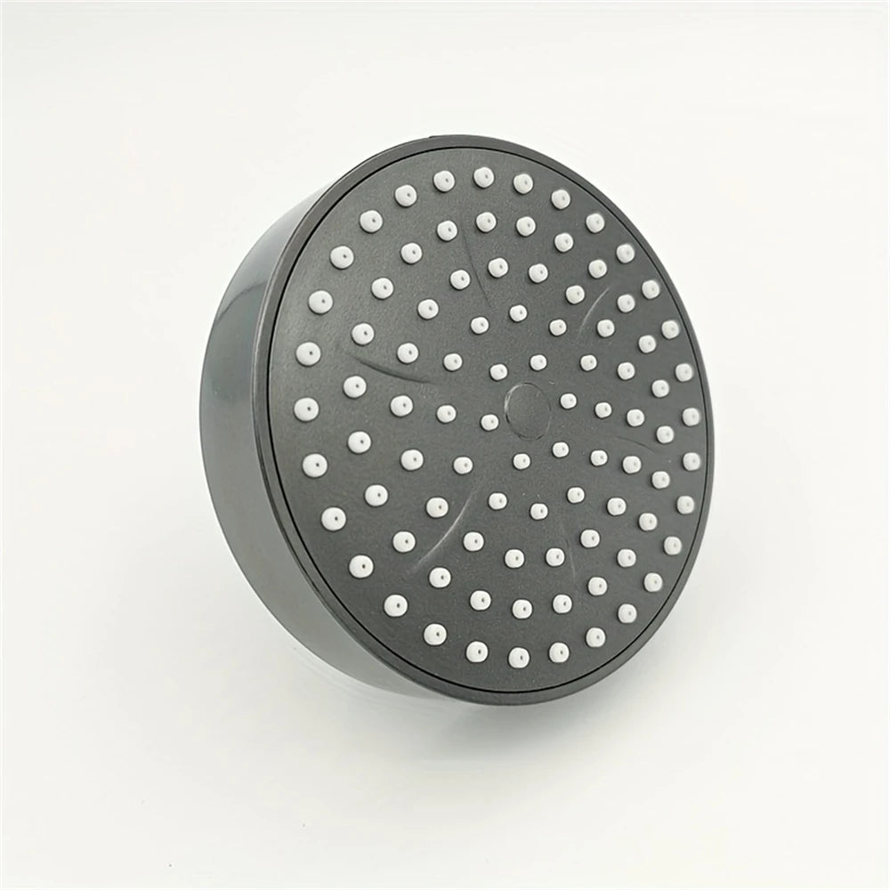 A matte black shower head with multiple small spray nozzles visible on the face.