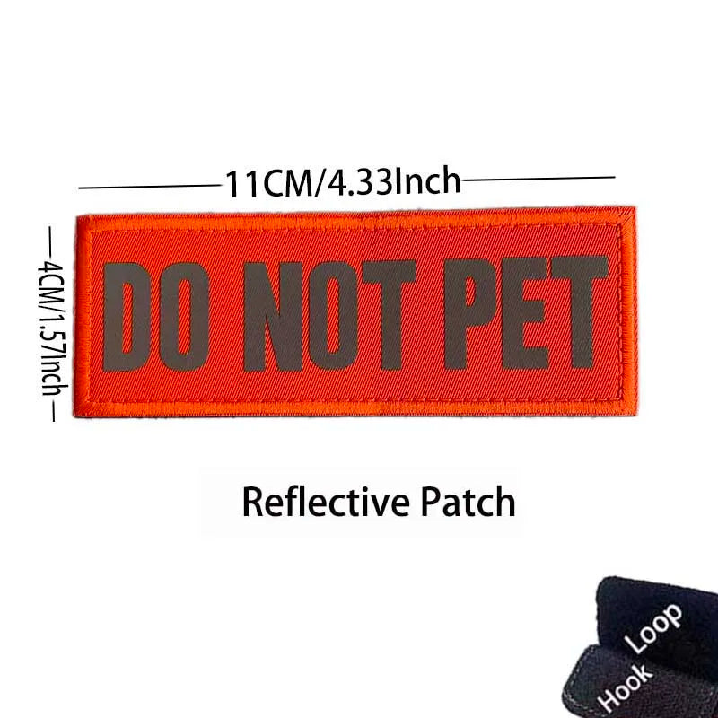An orange reflective patch embroidered with the text DO NOT PET on a fabric strap.