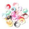A collection of colorful acrylic spacer beads in a wave pattern, including pink, green, white, and yellow shades.