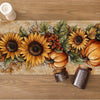 Autumn harvest table runner featuring sunflowers, pumpkins, and greenery on a wooden surface.