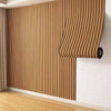 Vertical wood grain wall panels installed on a white wall, showing natural wood tones and vertical slats.
