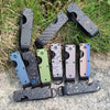 A collection of minimalist aluminum key organizers in various colors and finishes arranged on a natural outdoor background.