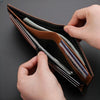 A hand is opening a brown leather wallet with a card holder and coin pocket, showing several cards inside.