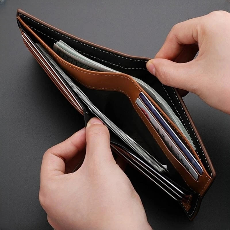 A hand is opening a brown leather wallet with a card holder and coin pocket, showing several cards inside.