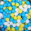 A large pile of colorful plastic balls in various shades of blue, yellow, and white.