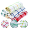 A stack of plaid kitchen towels in white, green, yellow, and blue patterns.