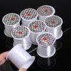 Rolls of white nylon beading cord for jewelry making stacked on a black surface.